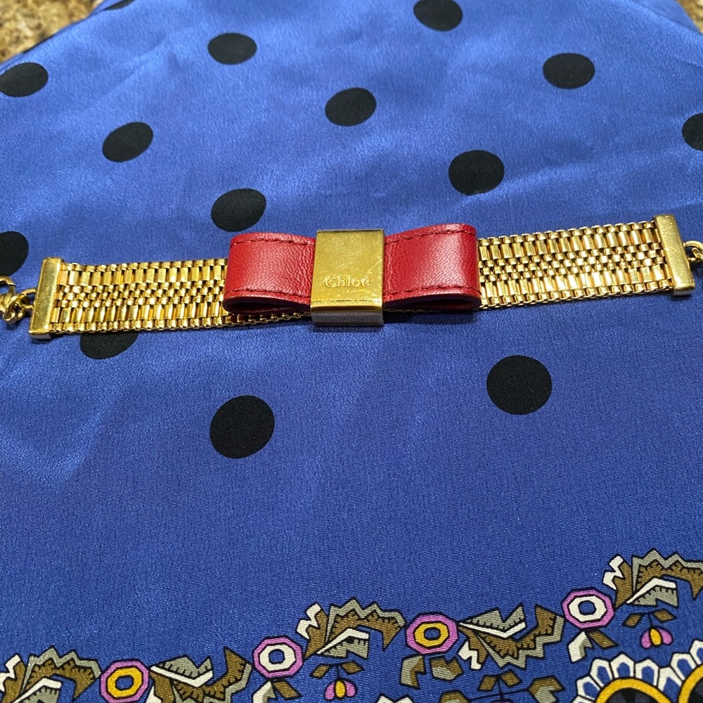 Authentic Chloe gold and red bow bracelet. Length 7”.